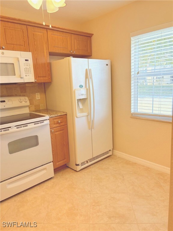 Kitchen featuring light tile patterned floors, whi