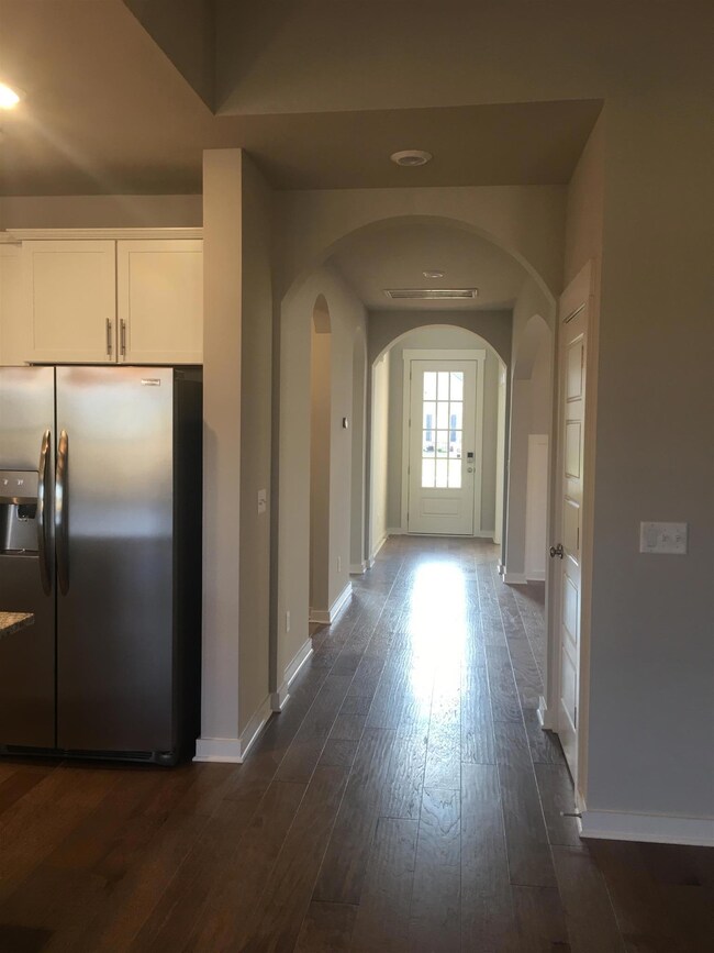 Tall ceilings and elegant archways looking from Family Rm towards the front door