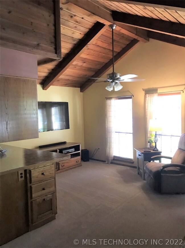 Den with vaulted cedar ceiling