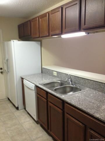 Sink side of Kitchen with Dishwasher and Refrigera