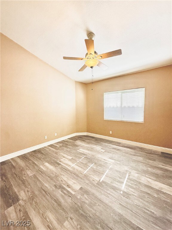 Unfurnished room featuring baseboards, ceiling fan