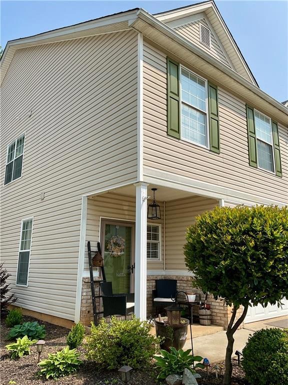 View of side of home featuring a patio area