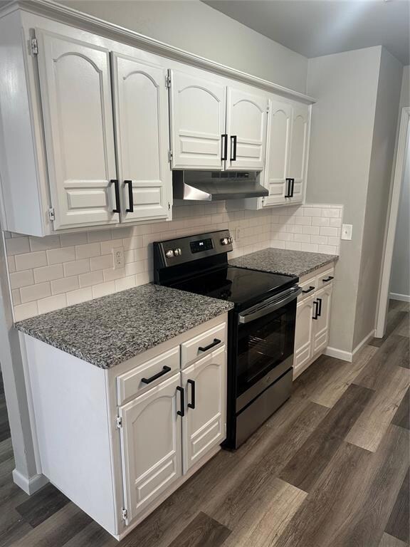 Kitchen with dark stone countertops, ventilation h