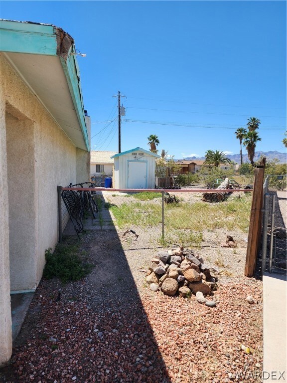 View of yard featuring a storage unit