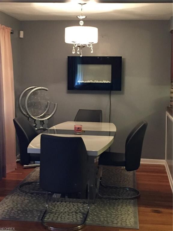 Dining room with hardwood floors open to kitchen