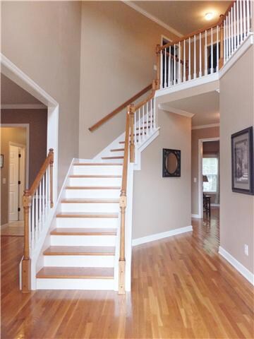 Welcome your Guests with this Amazing 2 Story Grand Foyer with Gleaming Hardwood Floors, Stunning Curved Staircase, and Gorgeous Chandelier. 
