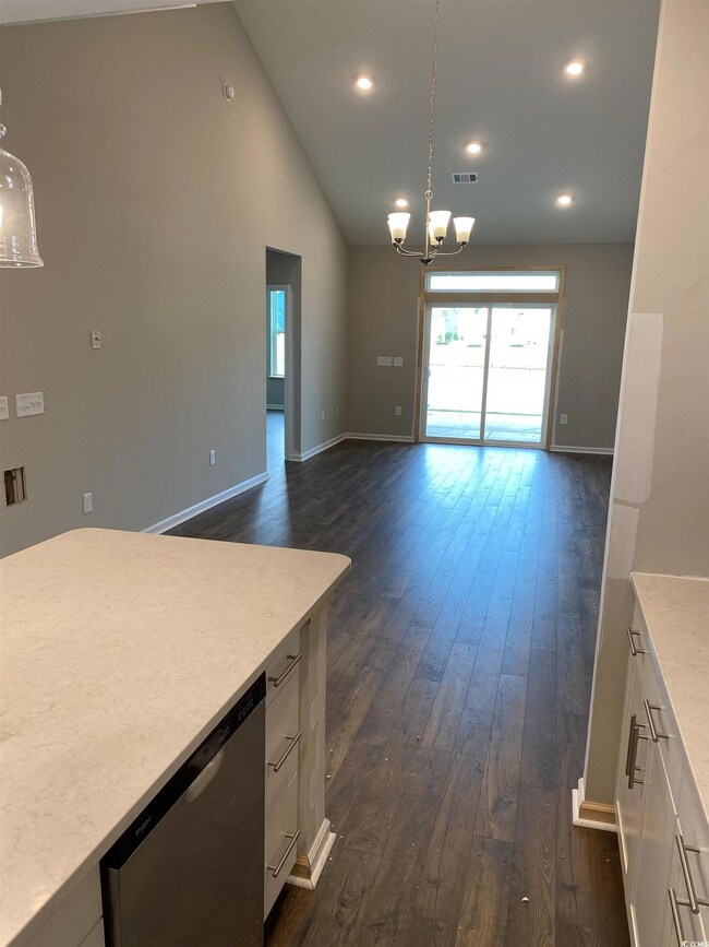 Interior space with dishwasher, a chandelier, dark