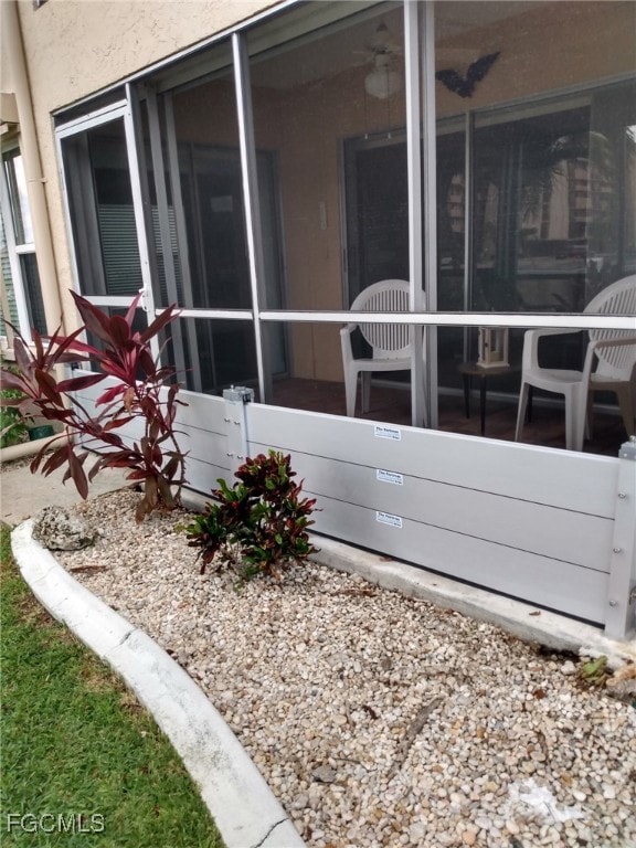 View of property exterior featuring a sunroom and stucco siding