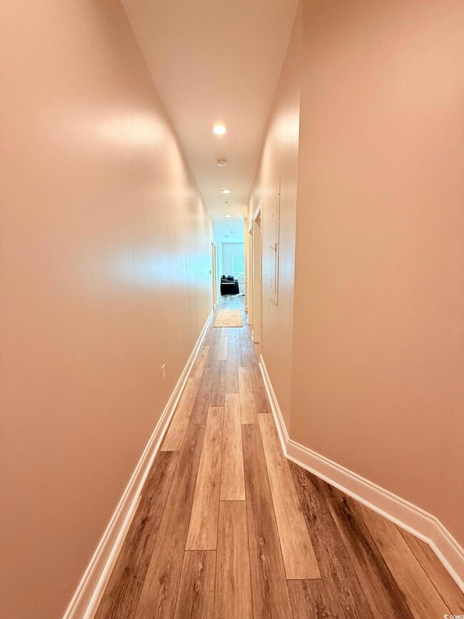 Hall featuring recessed lighting, baseboards, and light wood-type flooring