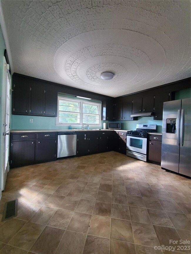 View of kitchen, custom ornate ceiling
