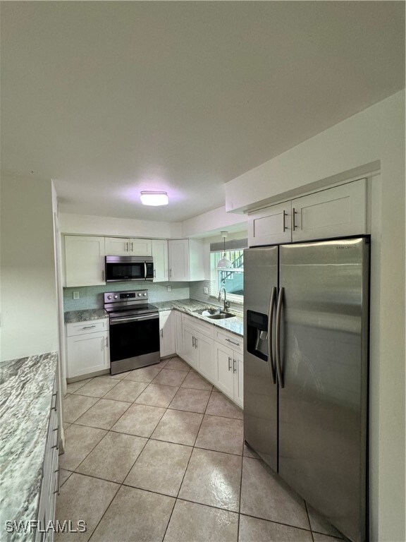 Kitchen featuring light tile patterned flooring, s