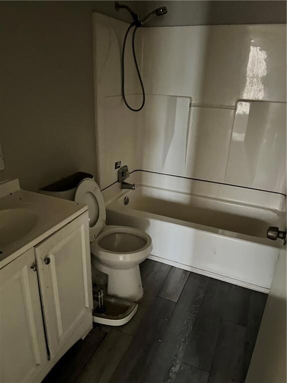 Full bathroom with vanity, hardwood / wood-style f