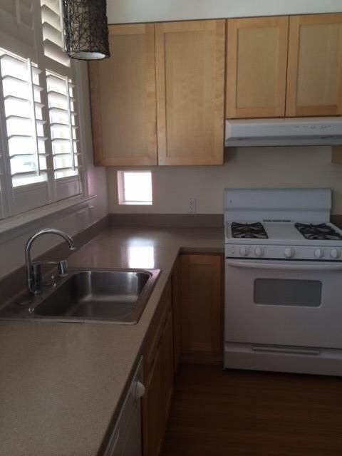 Kitchen has view of common grassy area.