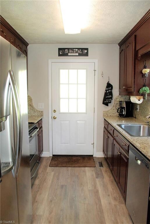 Kitchen with refreshed cabinets, new granite counters & stainless appliances