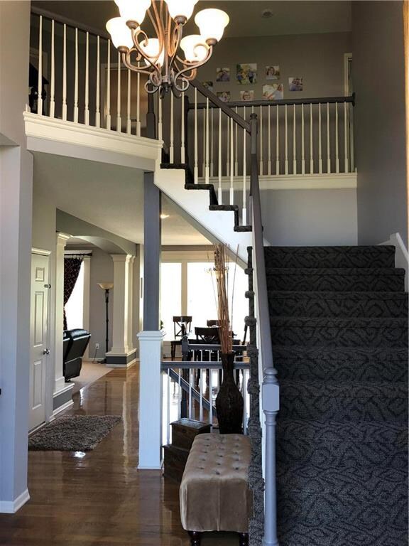 Grand Open Foyer with hardwood floor leads into th