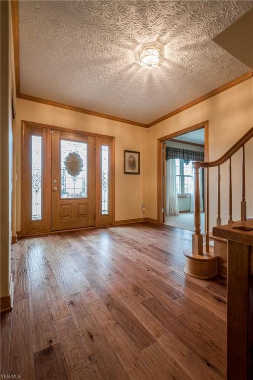 Foyer entry with crown molding and hickory floors.