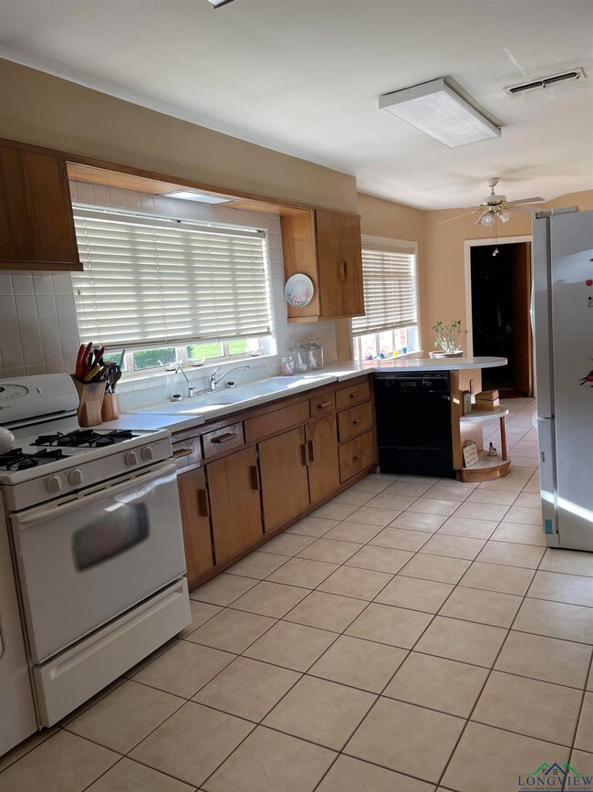 Kitchen featuring black dishwasher, light countert