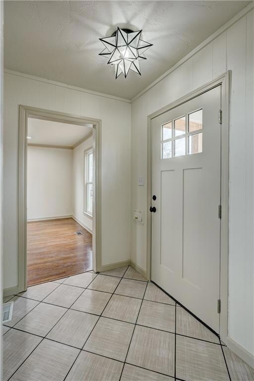 Bright Entryway with fun tile and an amazing light