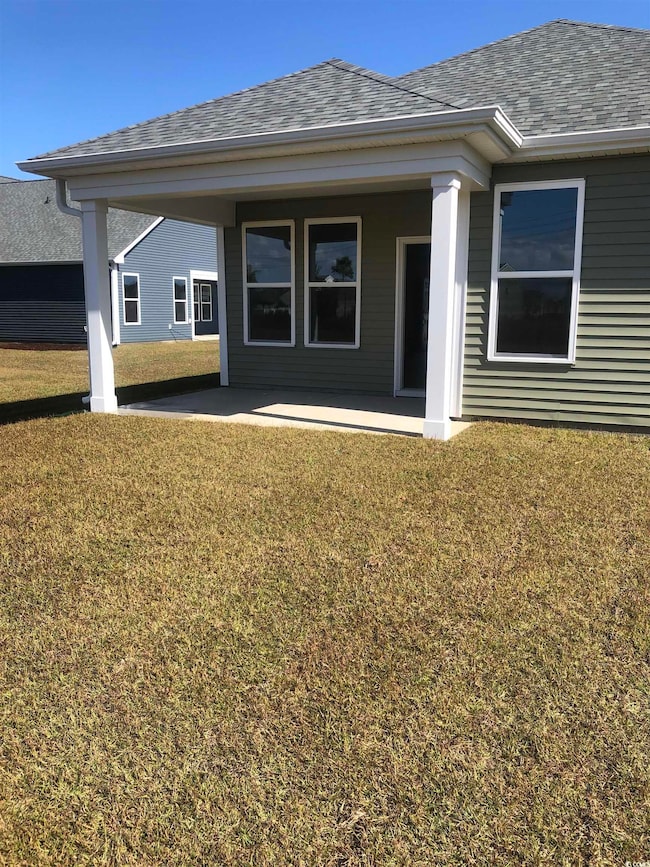Rear view of house with a patio and a yard