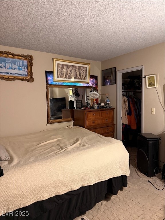 Bedroom featuring a textured ceiling, a closet, an
