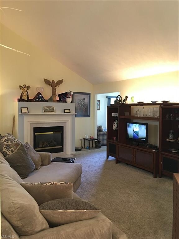 Living room with vaulted ceiling and gas fireplace