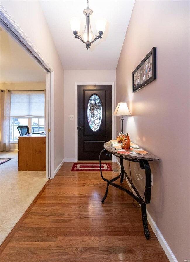Inviting entry foyer with hardwood flooring and va