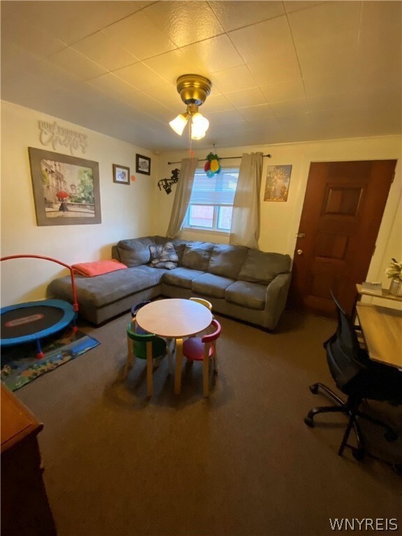 Living room in lower front apartment.  Brown door-