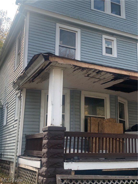 View of exterior entry with a porch