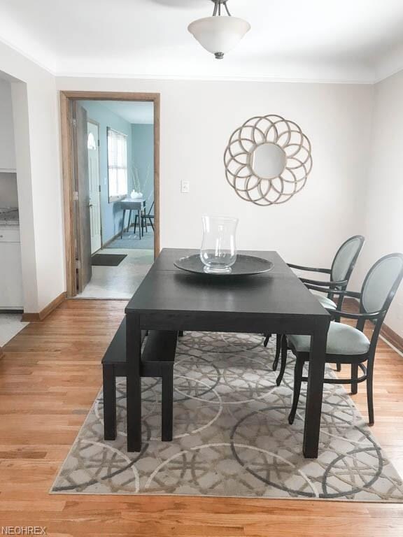 Formal dining room with hardwood flooring.
