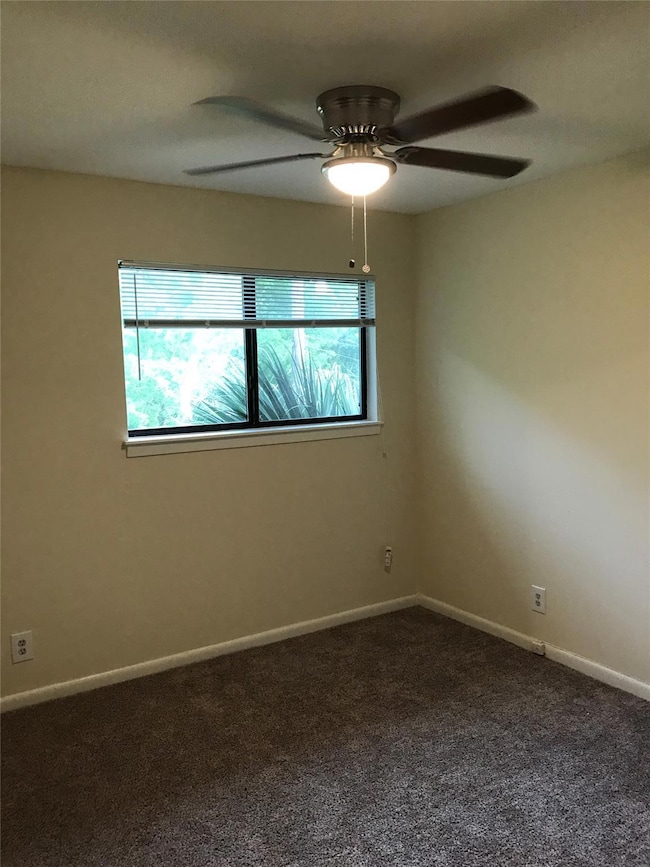 Spare room featuring baseboards, a ceiling fan, a