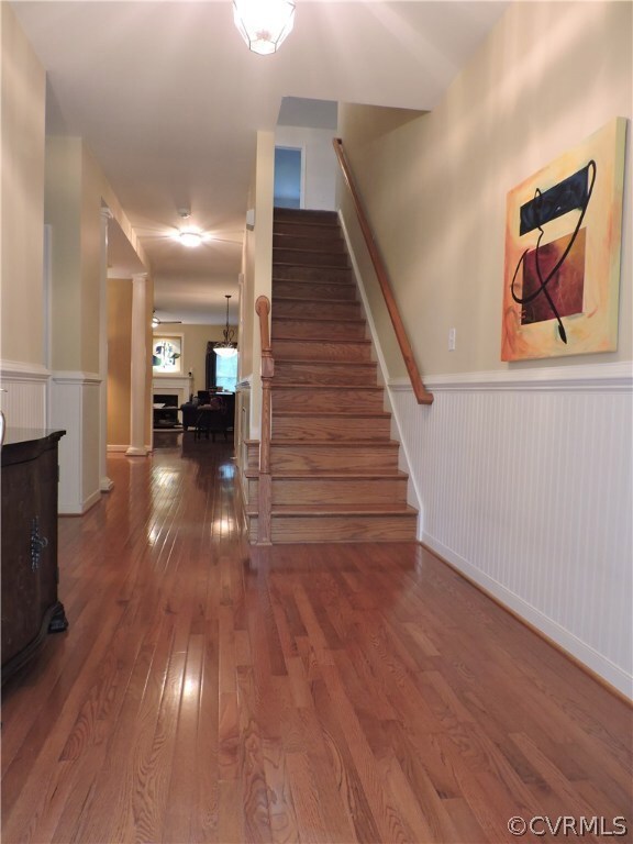 Foyer with chair rail, bead board, wood staircase