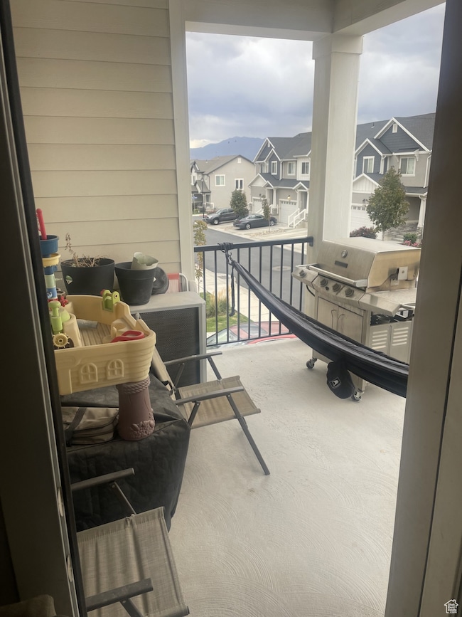 Balcony with a residential view and a grill