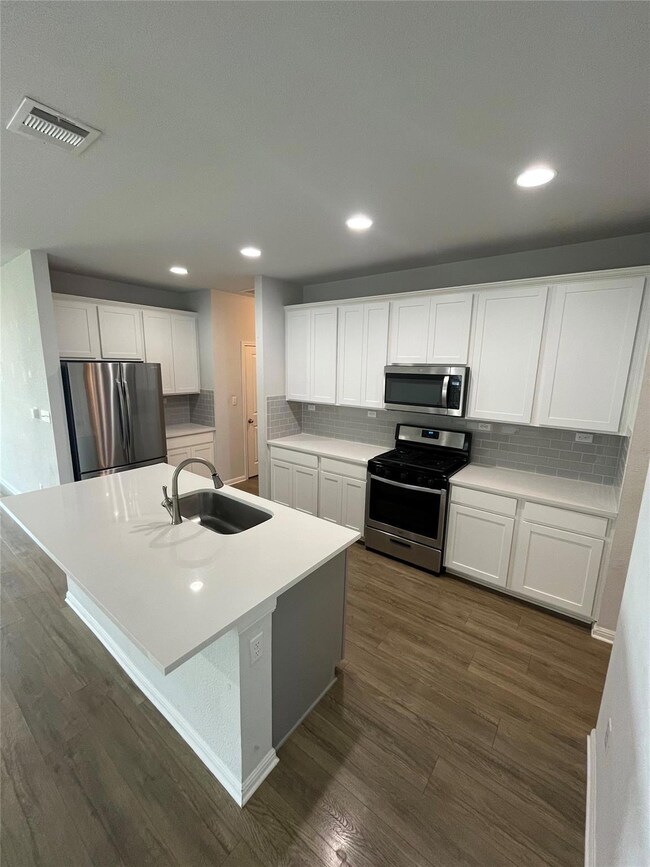Kitchen featuring appliances with stainless steel