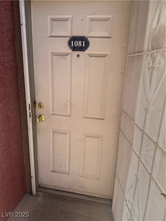 Doorway to property with stucco siding