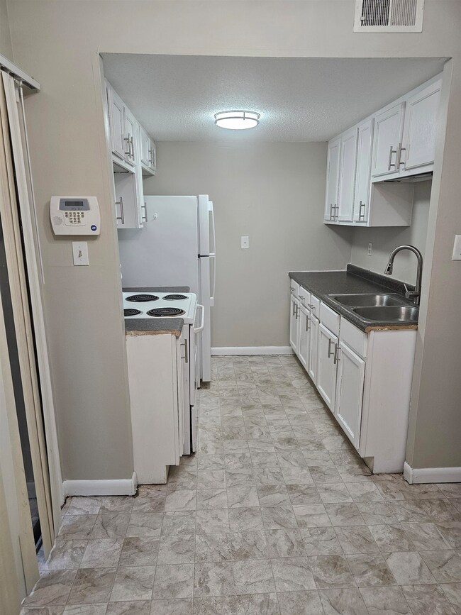 Kitchen featuring a sink, white electric range, wh