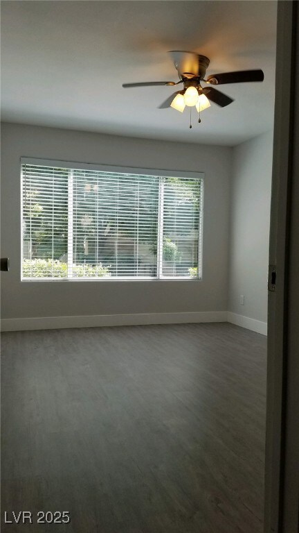 Unfurnished room with wood finished floors and a ceiling fan