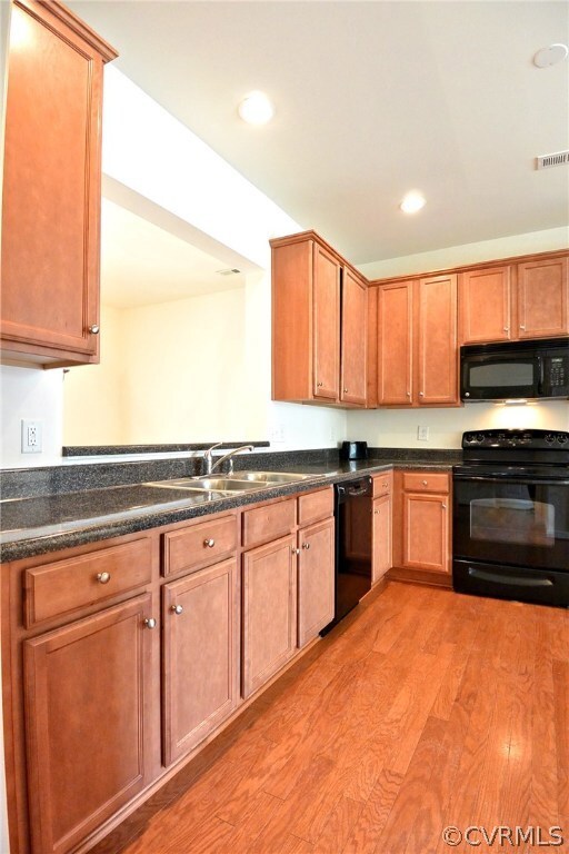 Kitchen with smooth top stove, dishwasher, wood fl