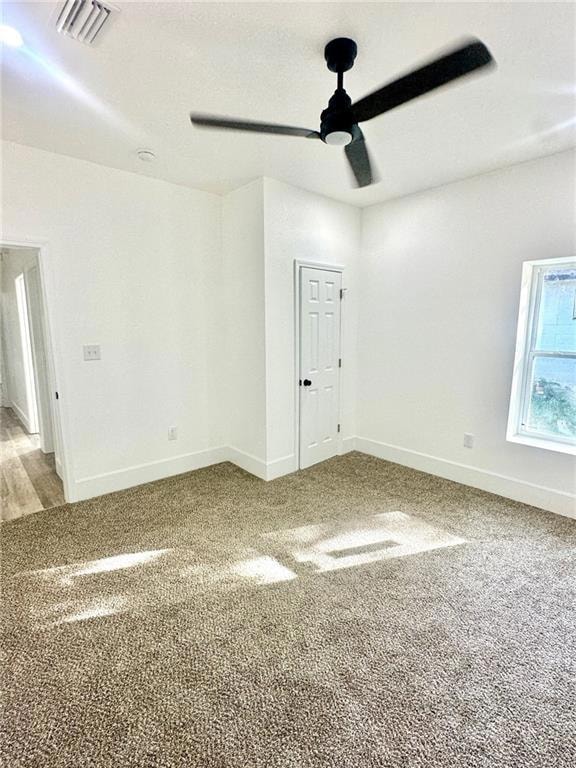 Unfurnished room with carpet flooring and a ceiling fan