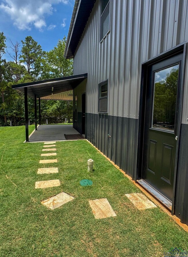 View of green lawn with a patio