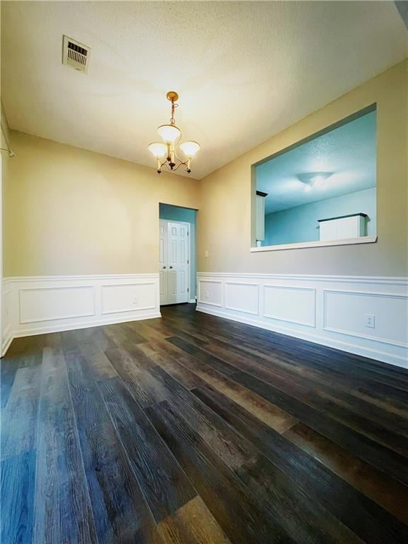 Spare room featuring a notable chandelier, visible
