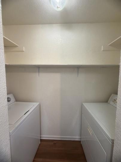 Laundry room with dark wood-type flooring, a text