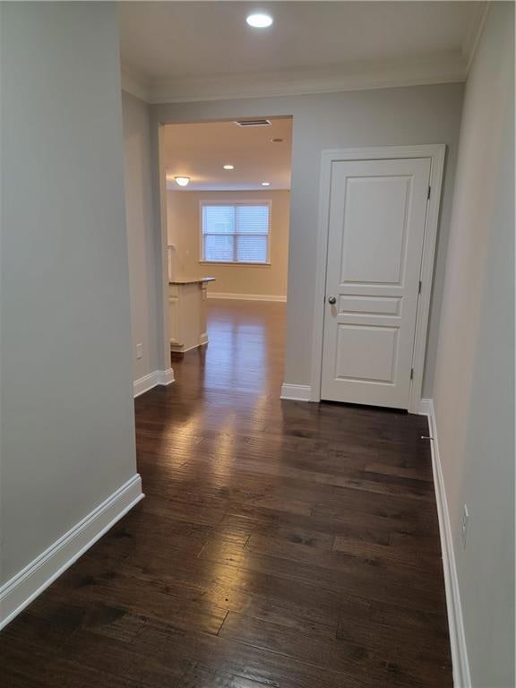 Hallway with ornamental molding, dark wood finishe