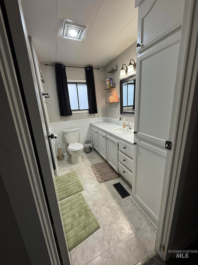 Bathroom with vanity and wainscoting