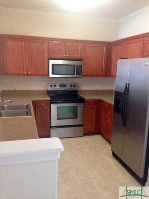 Open functional kitchen with cherry colored cabine