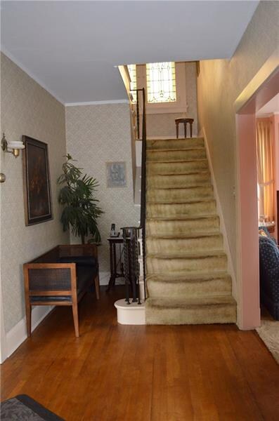 Spacious entry with hard wood floor, wrought iron 