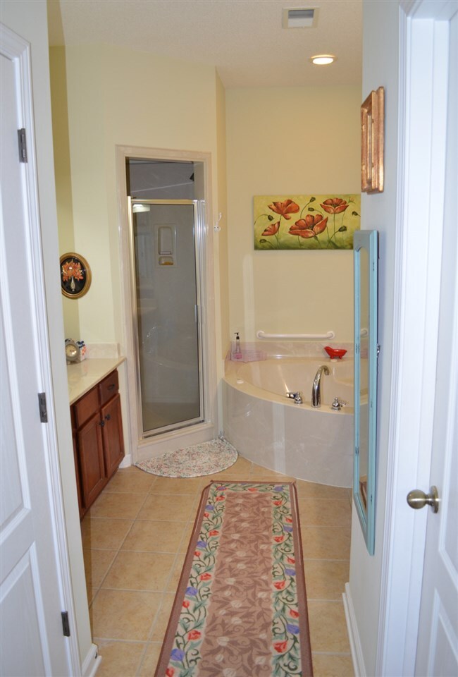 Whirlpool, separate shower, and double vanities
