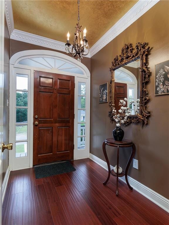 Foyer with ornamental molding, a notable chandelie