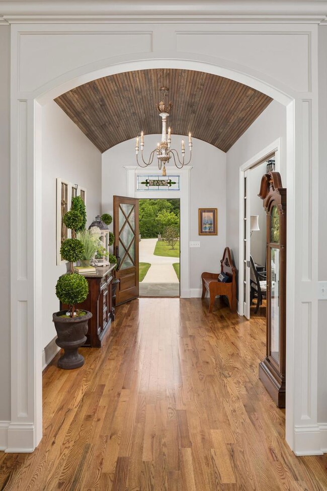Look at this view of the Mahogony and leaded glass front door, custom stained glass transom and the gorgeous barrel ceiling in the foyer!