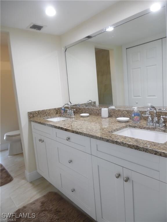 Bathroom with double vanity, a walk-in shower and