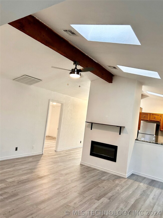 spacious living room with skylights